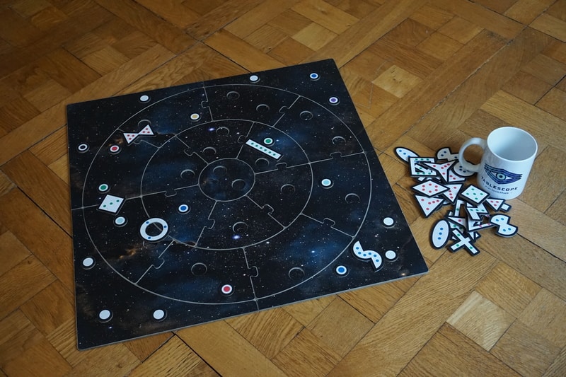 The board of a tabletop games with geometric tiles laid on it
